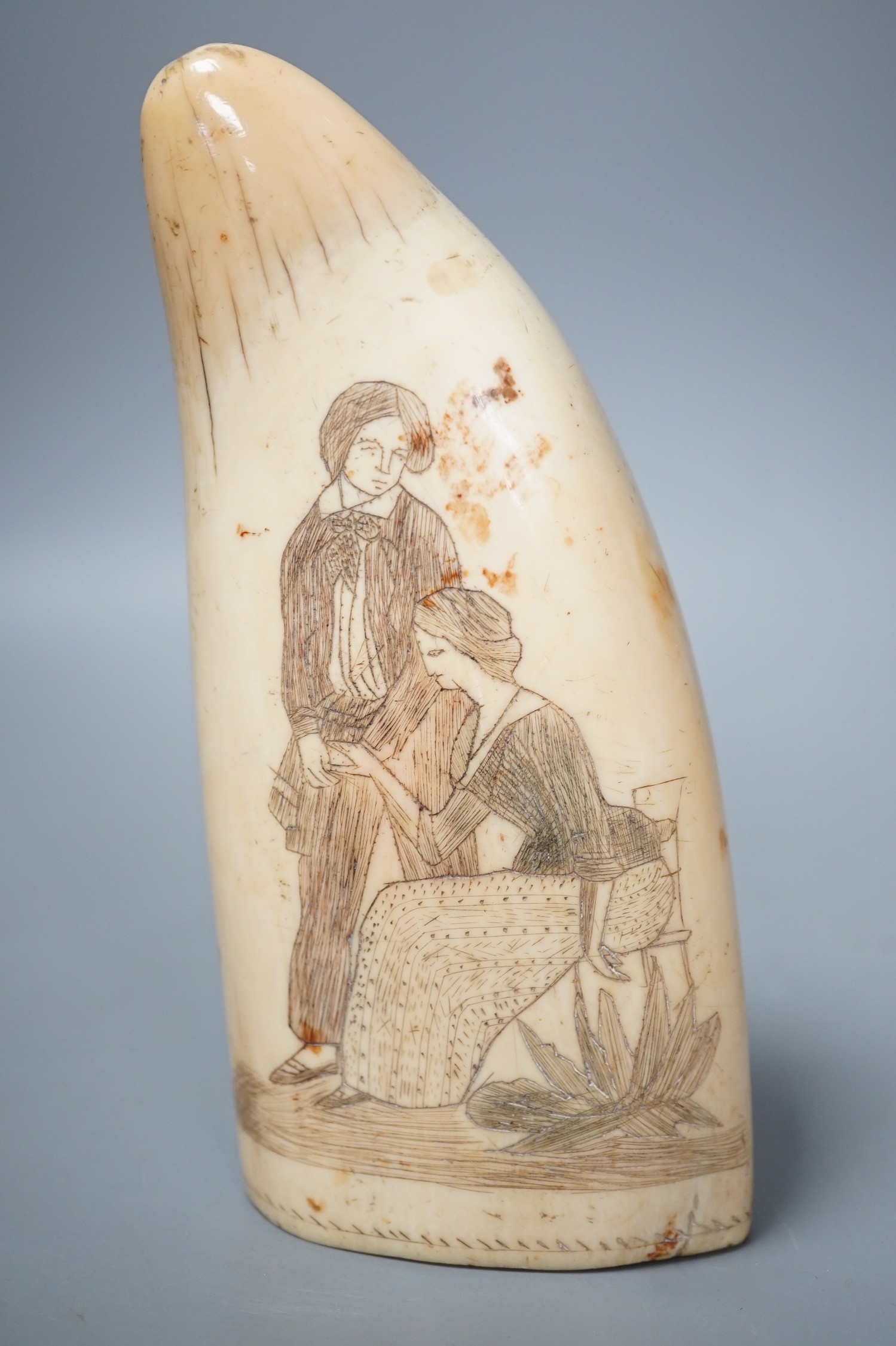 A 19th century scrimshaw whale tooth, 16cm